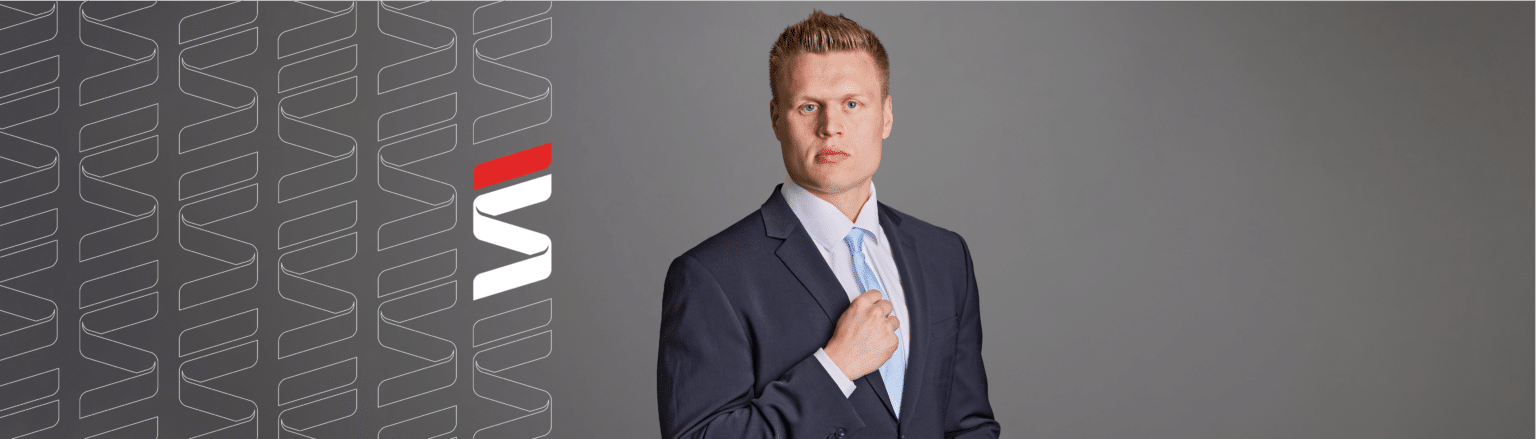 Phillip Sanberg, Fraser Stryker attorney, wearing a dark blue suit, white shirt and light blue tie. Fraser Stryker logo icon repeating on the left side of the photo.