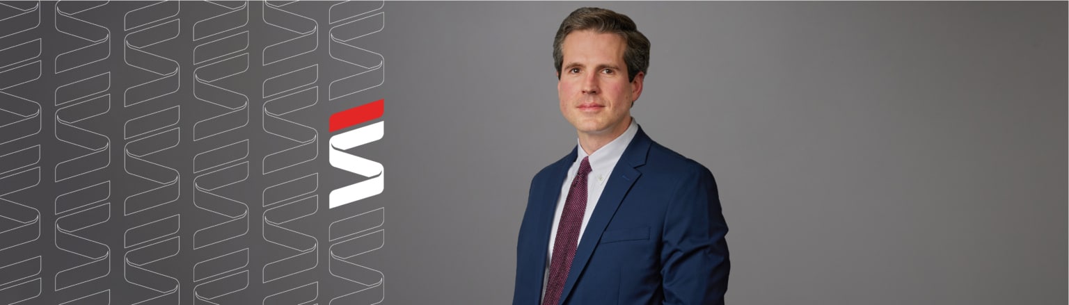 Mike Duffy, Fraser Stryker attorney, wearing a dark blue suit, white shirt and red tie.