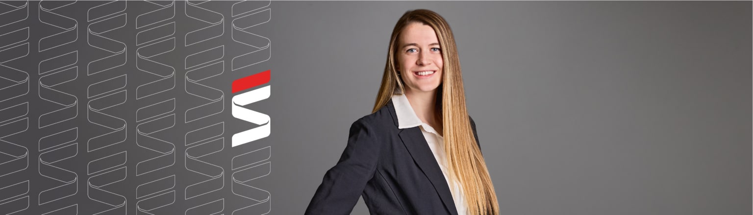 Photo of McKayla Sanders, wearing navy jacket and white shirt