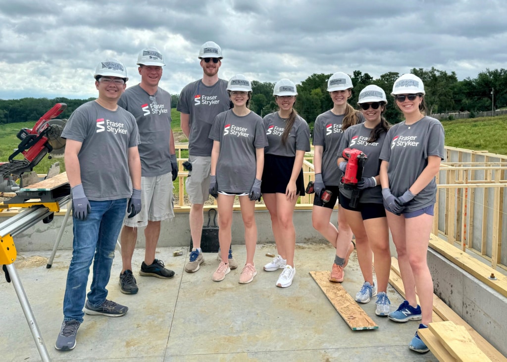 Photo of Daniel Ugarte, Luke Klinker, Jacob Craft, McKayla Sanders, Isabella Washka, Melanie Miller, Soffi Olson, and Lindsay Rudd outside at a Habitat for Humanity build site.