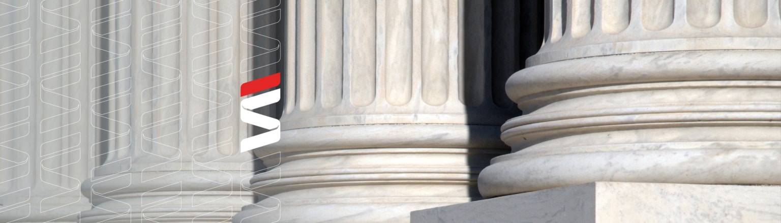 A close-up photograph of large, classical marble columns, possibly part of a courthouse or government building. Fraser Stryker logo pattern on the left side.